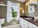 This bathroom boasts natural light, complemented by light-colored walls, modern fixtures, and tasteful decor at 5716 Trimmings Ct, Charlotte, NC 28226