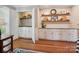 Elegant butler's pantry with white cabinets, a sink, and decorative shelves at 5716 Trimmings Ct, Charlotte, NC 28226