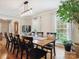 Light-filled dining room featuring wood floors, long table, and lovely views at 5716 Trimmings Ct, Charlotte, NC 28226