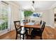 Elegant dining room featuring a large wooden table, modern chandelier, and stylish decor at 5716 Trimmings Ct, Charlotte, NC 28226