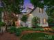 Charming two-story home features a well-manicured lawn and welcoming front porch at twilight at 5716 Trimmings Ct, Charlotte, NC 28226