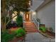 Inviting front entrance with brick steps, complemented by elegant landscaping and a charming, warm aesthetic at 5716 Trimmings Ct, Charlotte, NC 28226