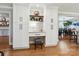 Built-in office nook with white cabinets, shelves, and a cozy seating area at 5716 Trimmings Ct, Charlotte, NC 28226