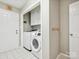 This laundry room offers a new Samsung washer and dryer set, white tile flooring, and extra storage for convenience at 5716 Trimmings Ct, Charlotte, NC 28226