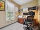 This home office offers ample natural light, built-in shelving, and a dedicated workspace at 5716 Trimmings Ct, Charlotte, NC 28226