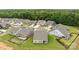 An aerial view of a residential area showcasing the layout of homes, roads, and landscaping at 7010 Brush Crk, Monroe, NC 28110