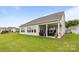 Expansive backyard featuring lush green grass, well-maintained landscaping, and a charming covered patio at 7010 Brush Crk, Monroe, NC 28110