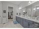 Elegant bathroom with double vanity, a large mirror, and walk-in closet with shelving at 7010 Brush Crk, Monroe, NC 28110