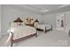 Bright bedroom showcasing two beds with carved headboards, accent pillows, and neutral carpeting at 7010 Brush Crk, Monroe, NC 28110