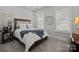 Cozy bedroom features a comfortable bed, neutral walls, and large windows with natural lighting at 7010 Brush Crk, Monroe, NC 28110