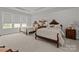 Bright bedroom featuring two beds with carved wooden headboards and decorative butterfly pillows at 7010 Brush Crk, Monroe, NC 28110