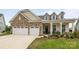 Charming exterior with a two-car garage, stone accents, and a welcoming front porch area at 7010 Brush Crk, Monroe, NC 28110