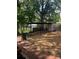 Fenced backyard features chain link enclosure, dog run, and a brick patio at 80 Pine St, Badin, NC 28009