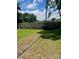 Grassy backyard with mature trees and a sturdy wood fence, perfect for outdoor enjoyment and privacy at 80 Pine St, Badin, NC 28009