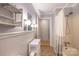 A well-lit bathroom with a shower, vanity, and storage, combining function with decor at 80 Pine St, Badin, NC 28009