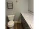 Bathroom showcasing a toilet, vanity, sink, marble countertop, and storage space for toiletries and essentials at 80 Pine St, Badin, NC 28009