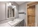 Cozy bathroom featuring a vanity with storage and a tiled shower stall at 80 Pine St, Badin, NC 28009