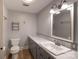 Bright bathroom featuring updated fixtures, toilet, and vanity with ample counter space at 80 Pine St, Badin, NC 28009