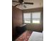 Bedroom featuring paneled walls, neutral carpet, ample natural light, and a ceiling fan at 80 Pine St, Badin, NC 28009