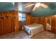 Cozy bedroom featuring unique ceiling design, wood paneling, and a ceiling fan at 80 Pine St, Badin, NC 28009