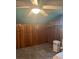 Bedroom with paneled walls, carpet, storage shelves, and ceiling fan at 80 Pine St, Badin, NC 28009