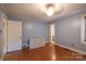 Comfortable bedroom with hardwood floors, a ceiling fan, and ample natural light for a cozy atmosphere at 80 Pine St, Badin, NC 28009