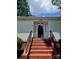 Inviting front entrance with brick steps and a white-trimmed glass door at 80 Pine St, Badin, NC 28009