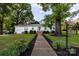 Charming single-story home with landscaped front yard and inviting walkway leading to the entrance at 80 Pine St, Badin, NC 28009