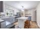 Spacious kitchen boasts gray countertops, stainless steel appliances, and a functional center island with barstool seating at 80 Pine St, Badin, NC 28009