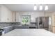 Well-lit kitchen showcases gray countertops, stainless steel appliances, and plenty of storage at 80 Pine St, Badin, NC 28009