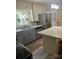 Kitchen features stainless steel appliances, an island, and gray lower cabinets at 80 Pine St, Badin, NC 28009