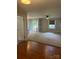 Inviting living room with neutral walls, plush carpet, and entry to home's front door at 80 Pine St, Badin, NC 28009