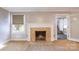 Cozy living room featuring a fireplace with tile surround, neutral carpet, and adjacent doorway at 80 Pine St, Badin, NC 28009