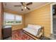This is a sunny living room with a sofa, rug, windows, and ceiling fan for relaxing at 80 Pine St, Badin, NC 28009