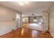 Open-concept living room featuring hardwood floors, neutral walls, fireplace, and an abundance of natural light at 80 Pine St, Badin, NC 28009