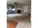Cozy living room featuring a decorative fireplace, neutral carpet, and natural light at 80 Pine St, Badin, NC 28009