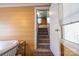 View of a carpeted staircase leading to an upper floor, bathed in natural light at 80 Pine St, Badin, NC 28009