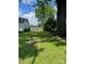 Spacious backyard with mature trees and a privacy fence at 80 Pine St, Badin, NC 28009