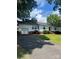 Spacious single-story home with attached garage, driveway, and well-kept lawn and landscaping at 80 Pine St, Badin, NC 28097