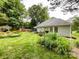 Landscaped backyard featuring a deck, grassy lawn, and privacy fence at 8105 Rachel Ct, Waxhaw, NC 28173