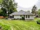 Landscaped backyard featuring a deck perfect for outdoor entertaining and beautiful lawn at 8105 Rachel Ct, Waxhaw, NC 28173