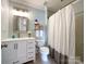 Clean bathroom featuring a single sink vanity, toilet and shower/tub combo at 8105 Rachel Ct, Waxhaw, NC 28173