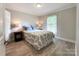 Bedroom featuring neutral paint colors, wood floors and large window at 8105 Rachel Ct, Waxhaw, NC 28173