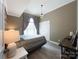 Bedroom with a large window, modern lighting, and natural wood accents at 8105 Rachel Ct, Waxhaw, NC 28173