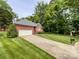 Beautiful brick home featuring a well-manicured lawn, attached garage, and mature trees at 8105 Rachel Ct, Waxhaw, NC 28173