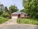 Well-maintained brick home with a two-car garage and a lush, green lawn at 8105 Rachel Ct, Waxhaw, NC 28173