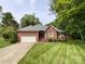 Charming single-story brick home featuring a well-manicured lawn and a two-car garage at 8105 Rachel Ct, Waxhaw, NC 28173