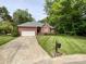 Beautiful brick home featuring a well-manicured lawn, attached garage, and mature trees at 8105 Rachel Ct, Waxhaw, NC 28173