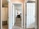 Hallway with views into bathroom and bedroom; white doors and neutral paint at 8105 Rachel Ct, Waxhaw, NC 28173