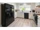 Modern kitchen with stainless steel appliances, quartz countertops, and white cabinetry at 8105 Rachel Ct, Waxhaw, NC 28173